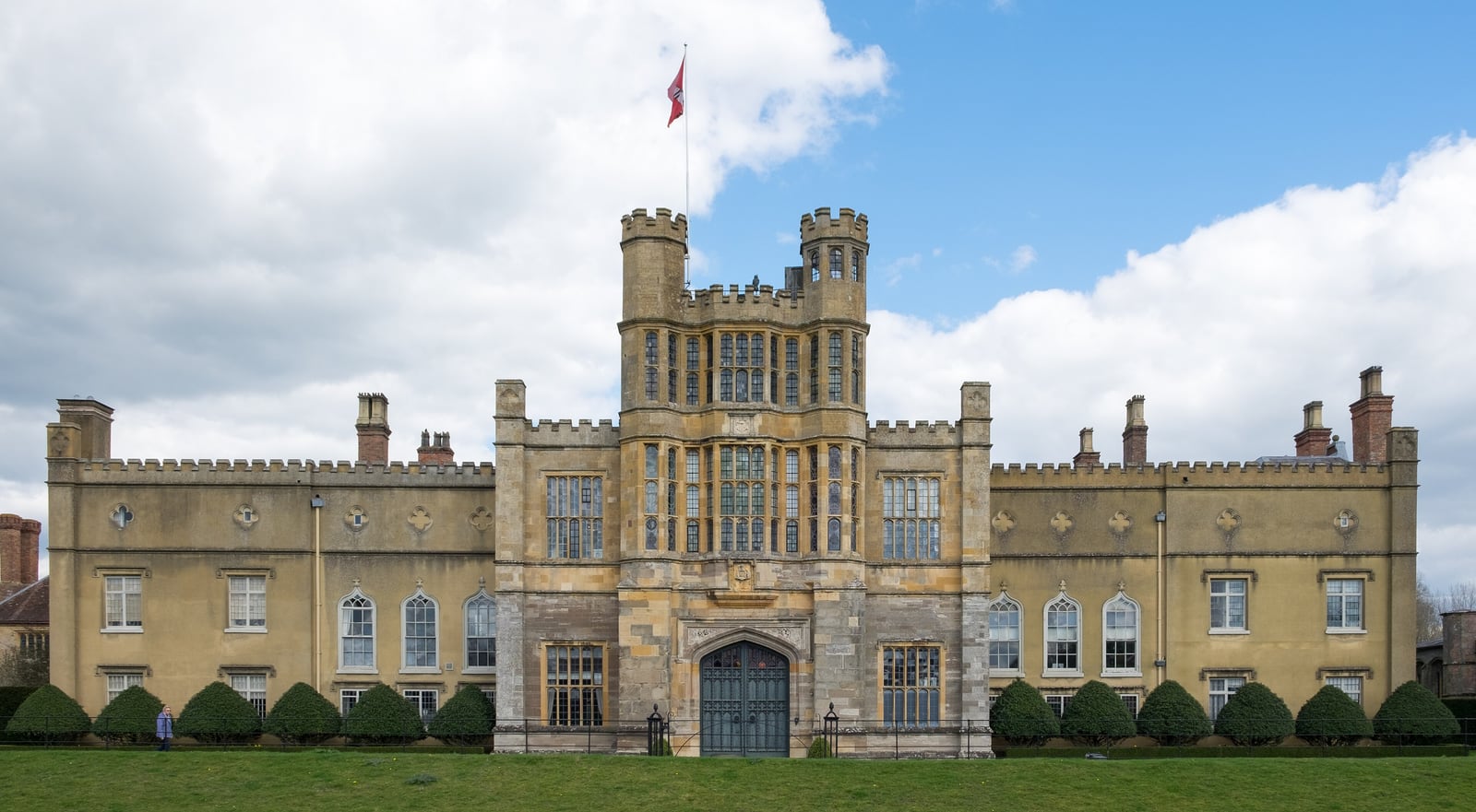 The west front of Coughton Court, Warwickshire, with its stone gatehouse tower.