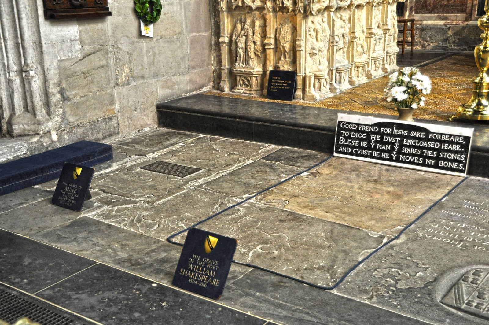 The chancel floor of Holy Trinity Church, Stratford, with Shakespeare's grave slab roped off and the board transcribing the curse on it.