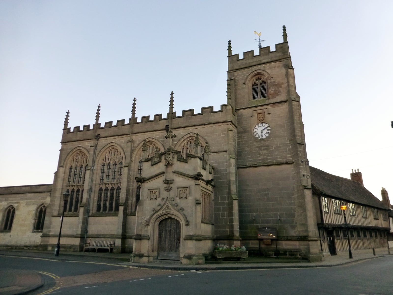 The Guild Chapel, Stratford-upon-Avon, from Chapel Lane: battlemented nave, north porch and west tower, with the Guildhall range beyond.