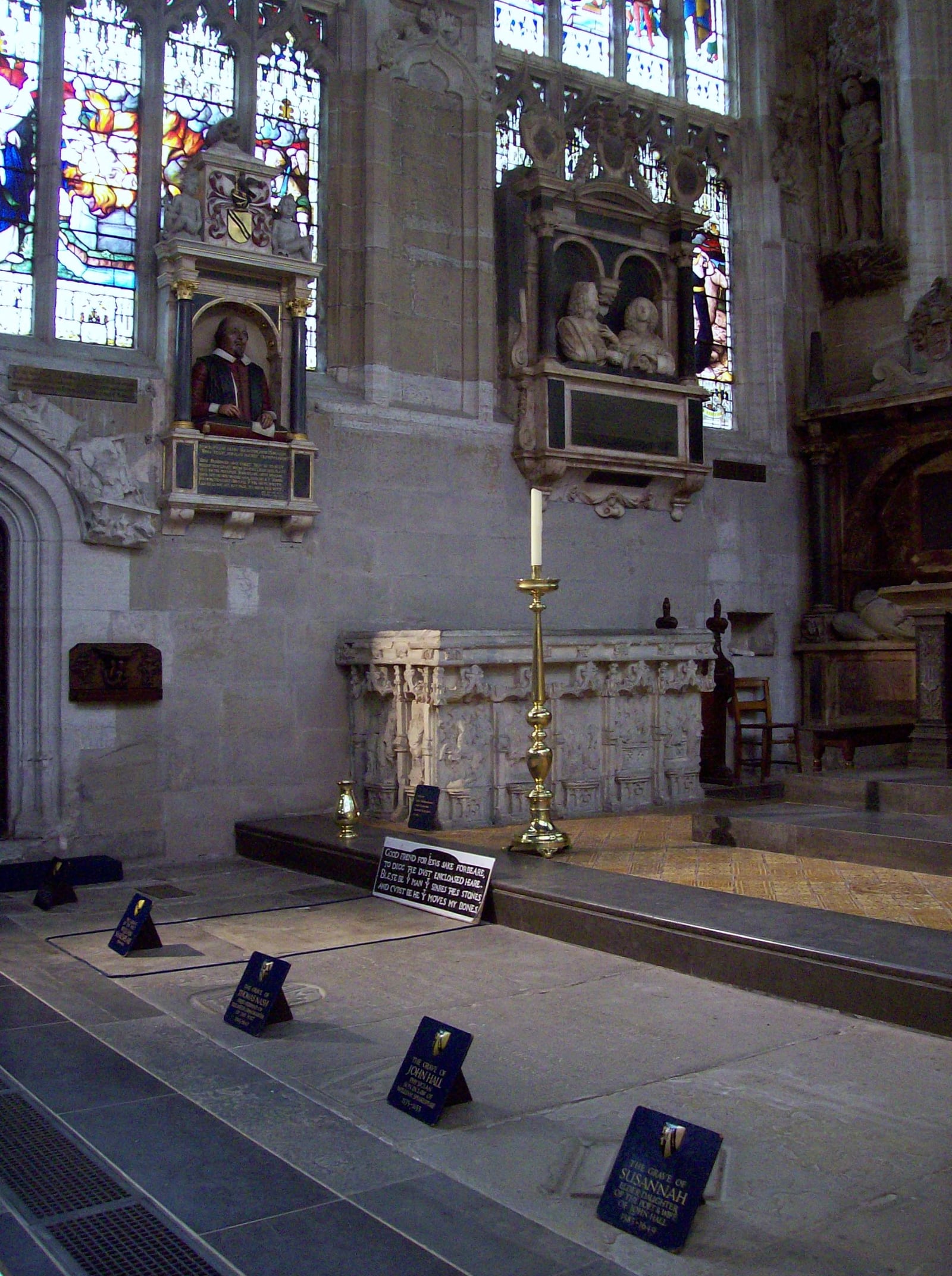 The row of family grave slabs in the chancel of Holy Trinity, Stratford, with the church's labels.
