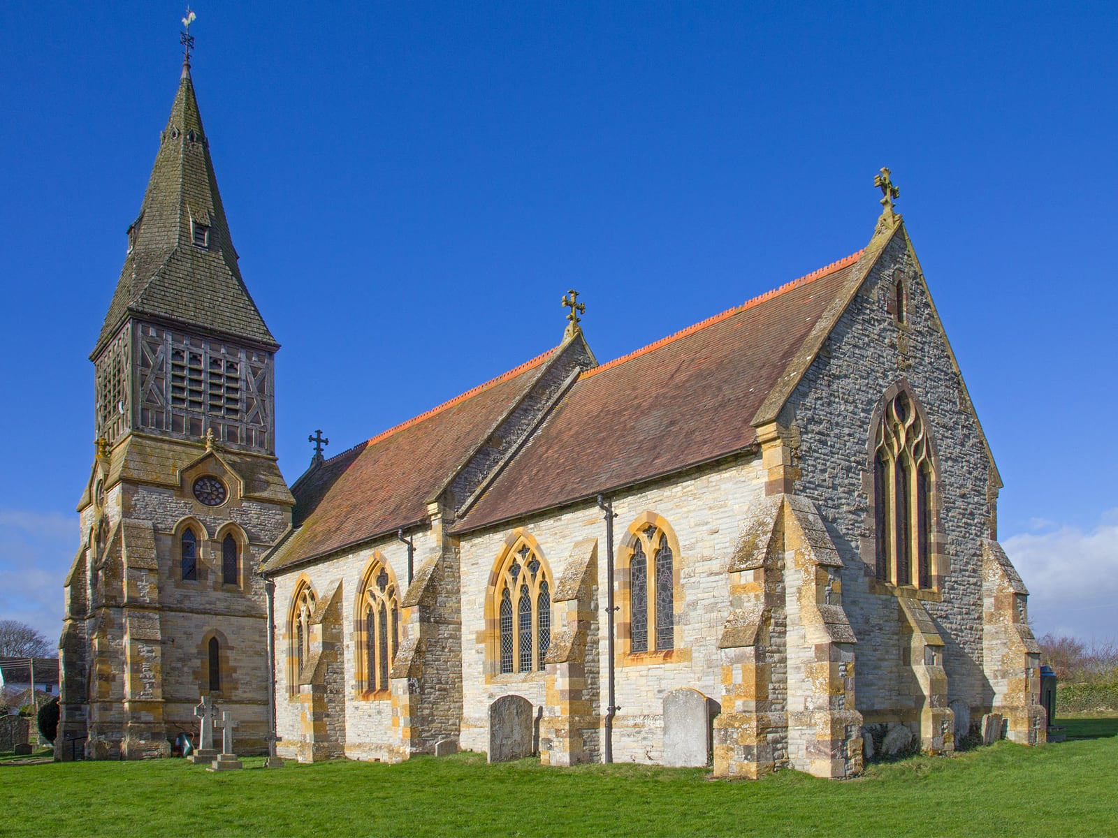St Andrew's Church, Temple Grafton, Warwickshire, a stone church with a shingled spire, seen from the south-east.